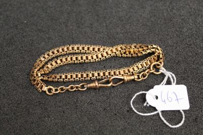 a close up of a gold chain with a tag on it