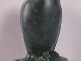 sculpture of a green owl on a green marble base