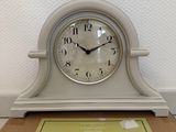a clock sitting on top of a box on the floor