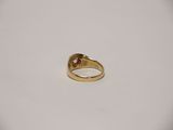a close up of a gold ring on a white surface