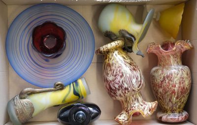 many different vases in a box on the shelf