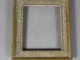 a gold picture frame with a white background