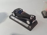 two toy cars sitting on a table next to each other