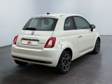 the back of a white fiat car parked in a white room