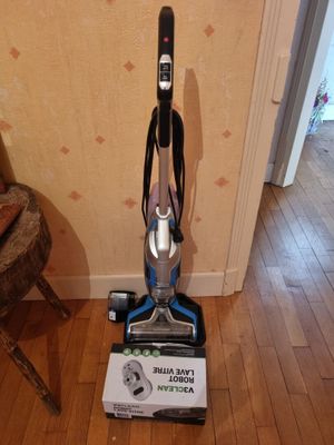 a vacuum that is sitting on a hard wood floor