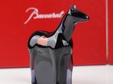 a black horse figurine sitting in front of a red box