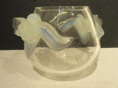 a glass vase with a flower inside of it on a table