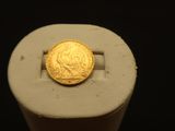 a gold coin sitting on top of a white object