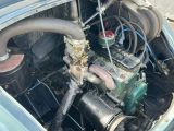 a car engine with a hose attached to it ' s hood