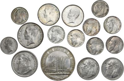 a close up of a bunch of coins on a white surface