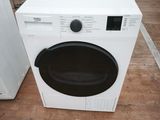 a white washer and dryer sitting next to each other on the floor