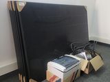 a pile of books sitting on the floor next to a television