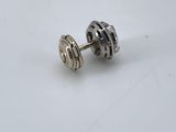 a close up of a pair of silver earrings on a white surface