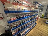 many different types of electronic devices on the shelves in the store