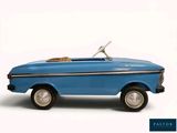 a blue toy car with a dog in the back seat