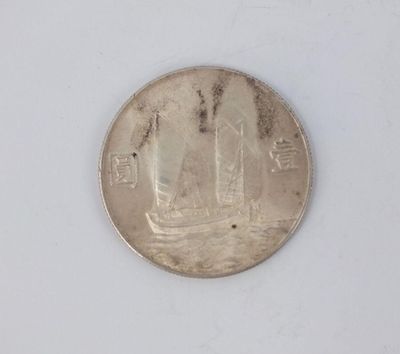 a coin with a picture of a ship on it