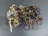 a pile of assorted bracelets and rings on a table