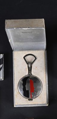a bottle opener with a picture of a woman in a red dress on it