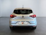the rear end of a silver car in a white room