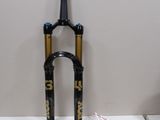a black and gold bike fork with a bag on the table