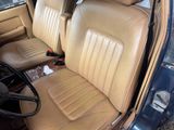 a tan leather seat in the back of a car