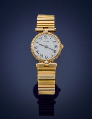a close up of a gold wrist watch with roman numerals