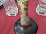 two vases sitting on a table with a clock in the background