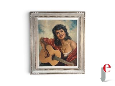 tableau représentant une femme avec une guitare, dans un cadre argenté