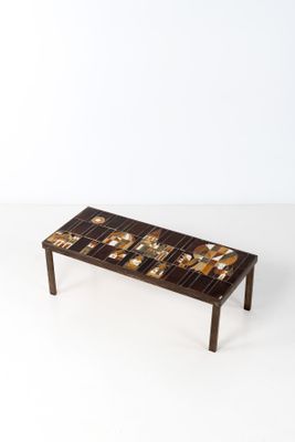 the coffee table is made out of wood and has a mosaic design on it