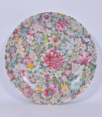 a colorful plate with flowers on it on a white surface