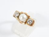 an image of a pearl and diamond ring on a white surface