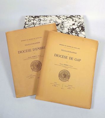 two books sitting next to each other on a white surface
