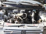 a dirty car with the hood open and the engine in the back