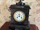 une petite horloge posée sur une table en bois