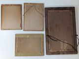 four pieces of old wood are displayed on a white surface