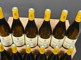 several bottles of wine are lined up on a wooden crate