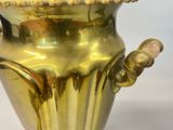 a gold vase that is sitting on a table