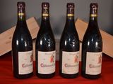 three bottles of red wine sit on a red cloth next to a wooden box