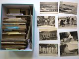 several old black and white photos are in a box on a table