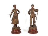 paire de figurines anciennes en bronze représentant un homme et une femme