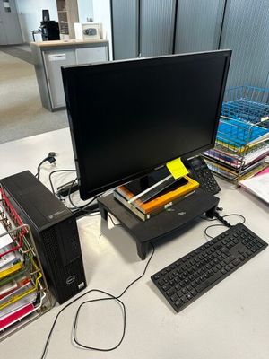 un ordinateur posé sur un bureau, avec un clavier et un écran