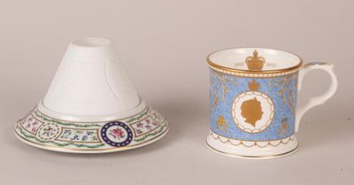 two cups and a saucer sitting next to each other