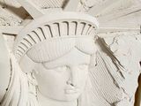 a statue of liberty that is on the wall of a building