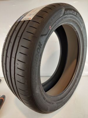 an image of a tire on a white surface next to a pair of pliers