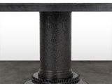 an image of a black dining table with a circular base