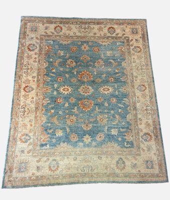 a blue and beige rug on a white background