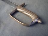 a close up of a sword on a table