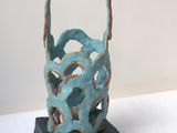 a small sculpture of a basket on a table