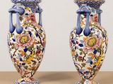 two vases that are sitting on a table