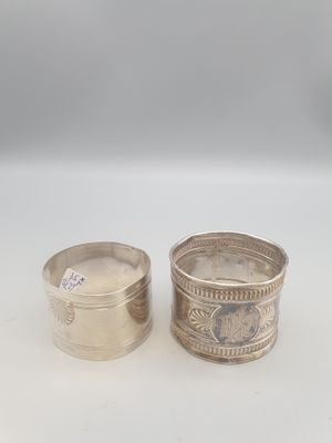 deux serviettes en argent, l'une avec un motif au recto et l'autre au verso
